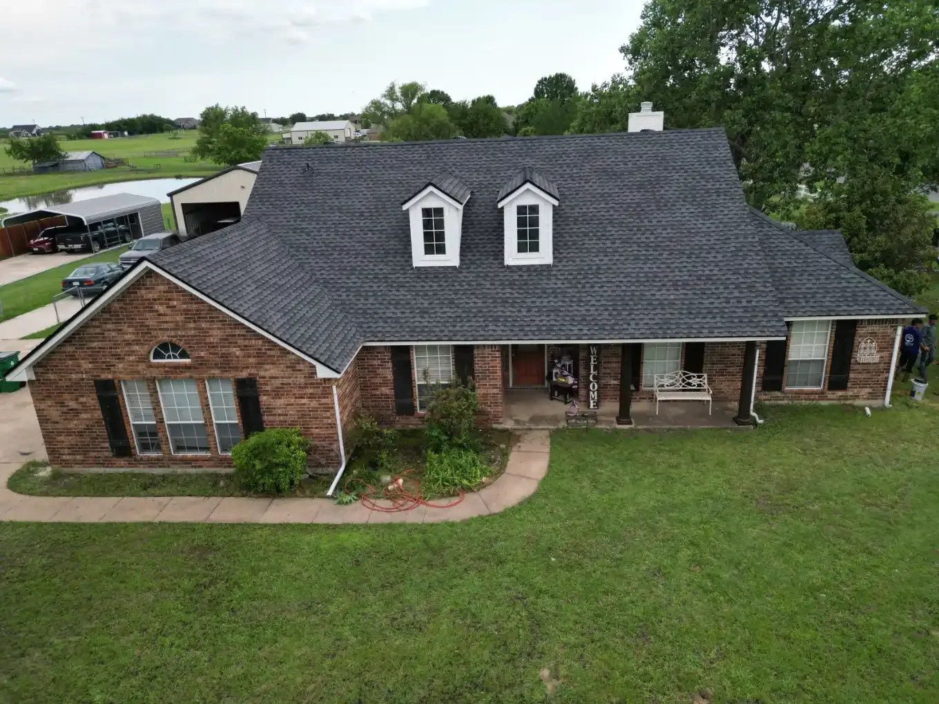 Aerial view of a finished roof on a brick home