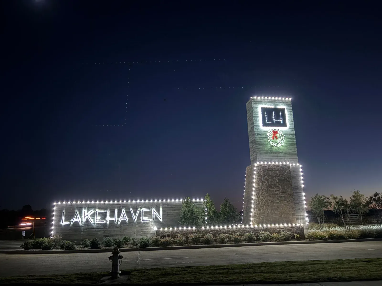 Lakehaven entrance sign lit with white holiday lights