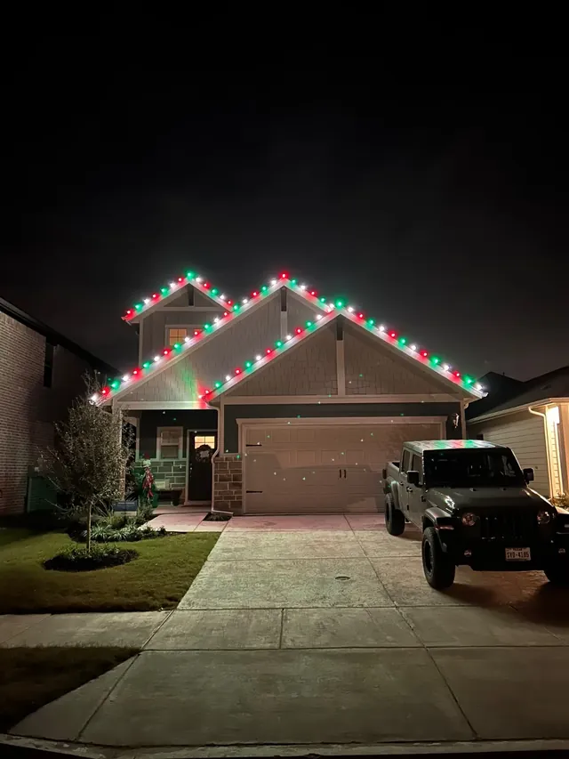 Home with red and green roofline lights