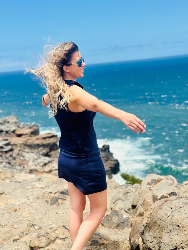 Jodi on a rocky coastline above the ocean